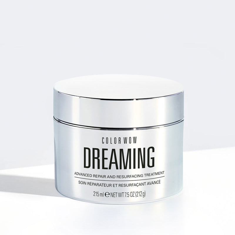 Color Wow Dreaming Advanced Repair and Resurfacing Treatment in a sleek silver jar, featuring a minimalist design with black lettering on a white background, providing advanced repair and resurfacing benefits.